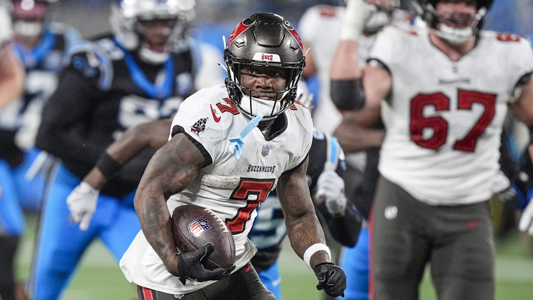Dec 1, 2024; Charlotte, North Carolina, USA; Tampa Bay Buccaneers running back Bucky Irving (7)  runs for yardage against the Carolina Panthers during the second half at Bank of America Stadium. Mandatory Credit: Jim Dedmon-Imagn Images