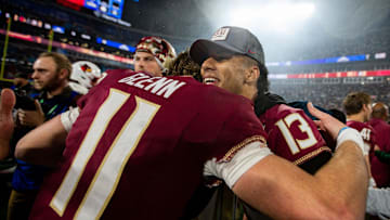 Florida State Seminoles quarterback Jordan Travis (13) hugs Florida State Seminoles quarterback Brock Glenn (11) as the team celebrates defeating the Louisville Cardinals 16-6 to claim the ACC Championship title in Charlotte, North Carolina on Saturday, Dec. 2, 2023.