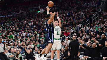 Apr 20, 2025; Boston, Massachusetts, USA; Boston Celtics guard Payton Pritchard (11) shoots a three point basket over Orlando Magic guard Cory Joseph (10) during the second half at TD Garden. Mandatory Credit: Bob DeChiara-Imagn Images