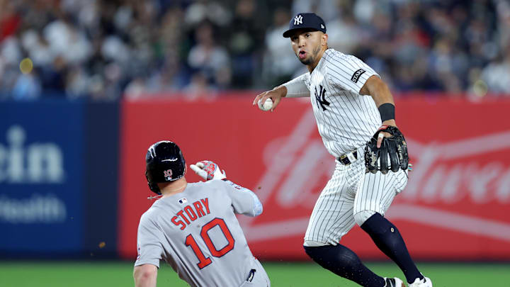 Jun 7, 2025; Bronx, New York, USA; New York Yankees shortstop Oswald Peraza (18) forces out Boston Red Sox shortstop Trevor Story (10) at second base and throws to first to complete a double play on a ball hit by Red Sox center fielder Ceddanne Rafaela (not pictured) during the seventh inning at Yankee Stadium. Mandatory Credit: Brad Penner-Imagn Images