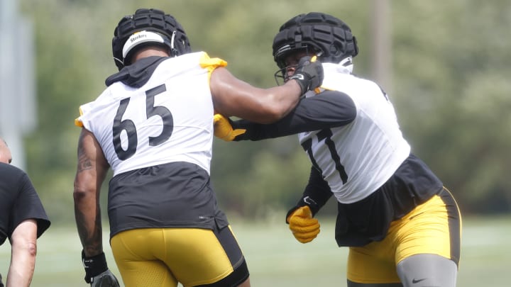 Jul 27, 2023; Latrobe, PA, USA;  Pittsburgh Steelers offensive tackle Dan Moore Jr. (65) works against offensive tackle Broderick Jones (77) in drills during training camp at Saint Vincent College. Mandatory Credit: Charles LeClaire-USA TODAY Sports