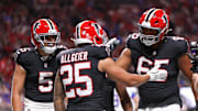 Atlanta Falcons running back Tyler Allgeier reacts with guard Matthew Bergeron 
