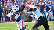 Sep 28, 2025; Orchard Park, New York, USA; Buffalo Bills running back James Cook (4) runs past New Orleans Saints defensive end Carl Granderson (96) in the first quarter at Highmark Stadium. Mandatory Credit: Mark Konezny-Imagn Images
