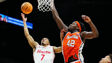 Nov 24, 2025; Las Vegas, Nevada, USA; Houston Cougars guard Milos Uzan (7) drives to the hoop past Syracuse Orange forward William Kyle III (42) during the first half of a 2025 Players Era Festival group play game at MGM Grand Garden Arena. Mandatory Credit: Stephen R. Sylvanie-Imagn Images
