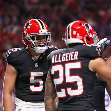 Atlanta Falcons running back Tyler Allgeier reacts with guard Matthew Bergeron 