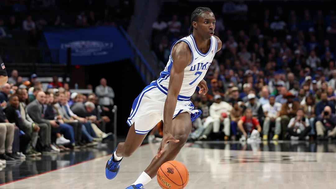 Nov 4, 2025; Charlotte, North Carolina, USA; Duke Blue Devils guard Dame Sarr (7) drives the ball against the Texas Longhorns during the first half of Dick Vitale’s Invitational game at Spectrum Center.