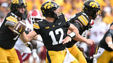 Sep 14, 2024; Iowa City, Iowa, USA; Iowa Hawkeyes quarterback Cade McNamara (12) throws a pass during the second quarter against the Troy Trojans at Kinnick Stadium. Mandatory Credit: Jeffrey Becker-Imagn Images