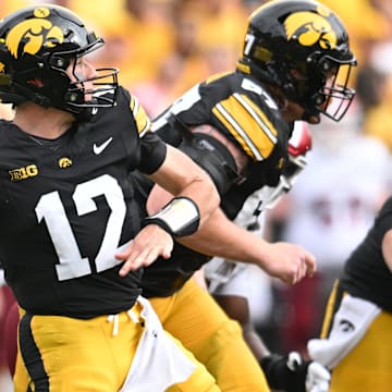 Sep 14, 2024; Iowa City, Iowa, USA; Iowa Hawkeyes quarterback Cade McNamara (12) throws a pass during the second quarter against the Troy Trojans at Kinnick Stadium. Mandatory Credit: Jeffrey Becker-Imagn Images