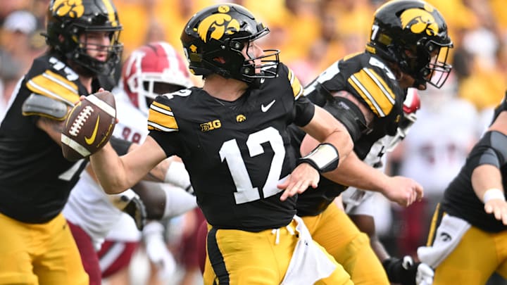 Sep 14, 2024; Iowa City, Iowa, USA; Iowa Hawkeyes quarterback Cade McNamara (12) throws a pass during the second quarter against the Troy Trojans at Kinnick Stadium. Mandatory Credit: Jeffrey Becker-Imagn Images