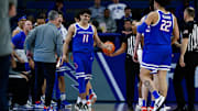 Boise State guard Alvaro Cardenas reacts with head coach Leon Rice and teammates.