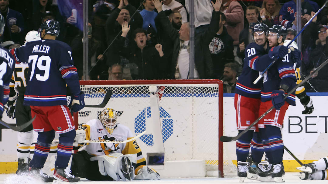 K'Andre Miller, Chris Kreider, and Reilly Smith celebrate a goal