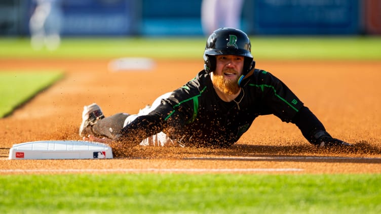 Dayton outfielder Blake Dunn slides back to first base