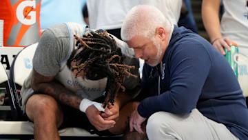 Oct 12, 2024; Cherokee, NC, USA;  Mandatory Credit:North Carolina Tar Heels guard RJ Davis (4) with the trainer on the bench in the second half at the Dean E. Smith Center. Bob Donnan-Imagn Images