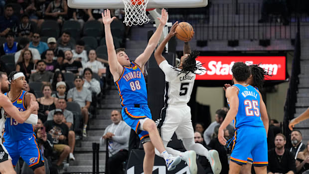 October 7, 2024; San Antonio, Texas, United States; San Antonio Spurs guard Stephon Castle (5) shoots over Oklahoma City Thunder guard Alex