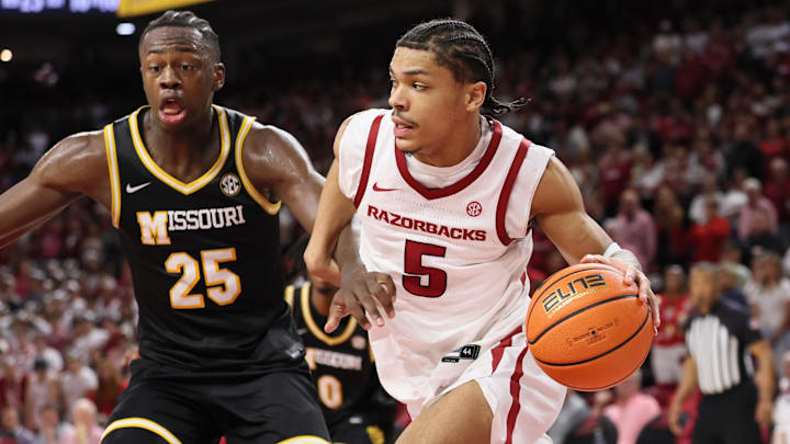 Feb 21, 2026; Fayetteville, Arkansas, USA; Arkansas Razorbacks guard Darius Acuff Jr (5) drives against Missouri Tigers guard Mark Mitchell (25) during the second half at Bud Walton Arena. Arkansas won 94-86. Mandatory Credit: Nelson Chenault-Imagn Images