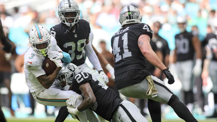 Nov 19, 2023; Miami Gardens, Florida, USA; Miami Dolphins wide receiver Robbie Chosen (3) is tackled by Las Vegas Raiders safety Isaiah Pola-Mao (20) during the second quarter at Hard Rock Stadium.