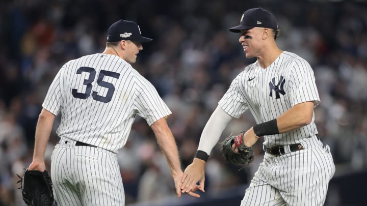 New York Yankees closer Clay Holmes and right fielder Aaron Judge celebrate after beating the Cleveland Guardians in game one of the ALDS for the 2022 MLB Playoffs at Yankee Stadium.