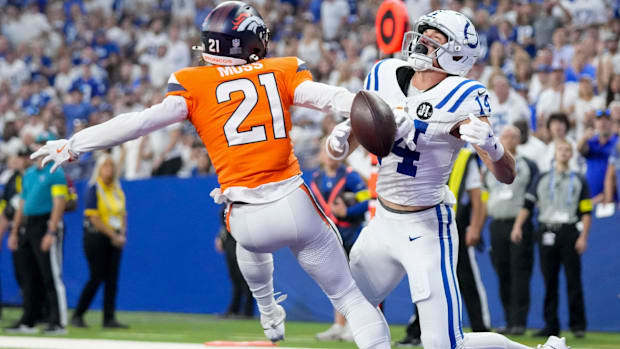 A pass intended for Indianapolis Colts wide receiver Alec Pierce (14) is broken up by Denver Broncos cornerback Riley Moss. 