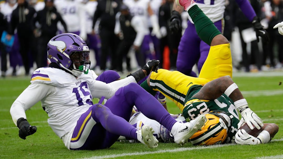 Green Bay Packers running back Emanuel Wilson (23) scores a touchdown against Minnesota Vikings linebacker Dallas Turner (15) in the third quarter during their football game Sunday, November 23, 2025, at Lambeau Field in Green Bay, Wisconsin.