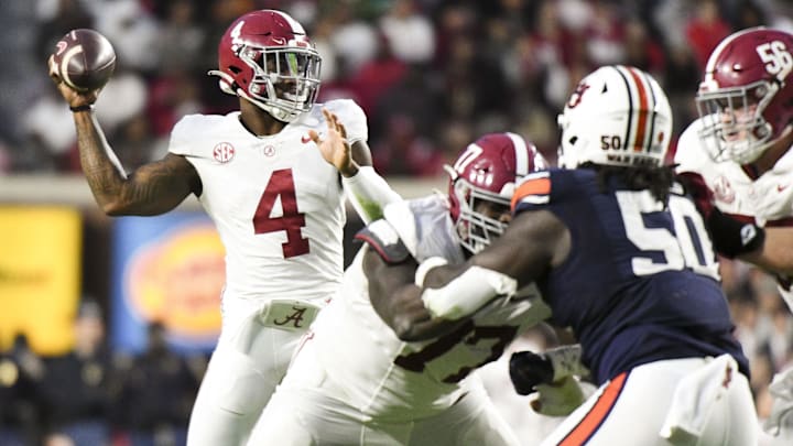 Nov 25, 2023; Auburn, Alabama, USA;  Alabama Crimson Tide quarterback Jalen Milroe (4) throws a pass against the Auburn Tigers at Jordan-Hare Stadium. Alabama won 27-24. Mandatory Credit: Gary Cosby Jr.-Imagn Images