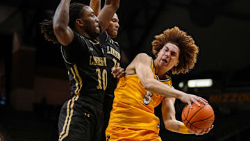 Nov 27, 2024; Columbia, Missouri, USA; Missouri Tigers guard T.O. Barrett (5) drives against Lindenwood Lions guard Jadis Jones (10) and guard Nathan Johnson Jr. (15) at Mizzou Arena. Mandatory Credit: Jay Biggerstaff-Imagn Images