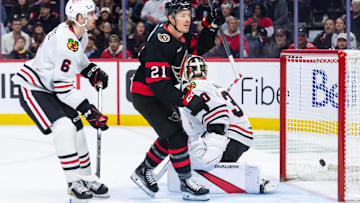 Apr 15, 2025; Ottawa, Ontario, CAN; Ottawa Senators center Nick Cousins (21) scores against Chicago Blackhawks goalie Spencer Knight (30) in the first period at the Canadian Tire Centre. Mandatory Credit: Marc DesRosiers-Imagn Images