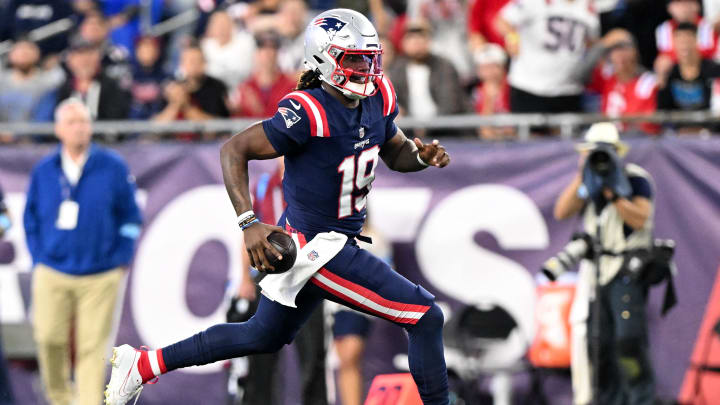 New England Patriots quarterback Joe Milton runs against the Carolina Panthers at Gillette Stadium. New England Patriots quarterback Joe Milton runs against the Carolina Panthers at Gillette Stadium.