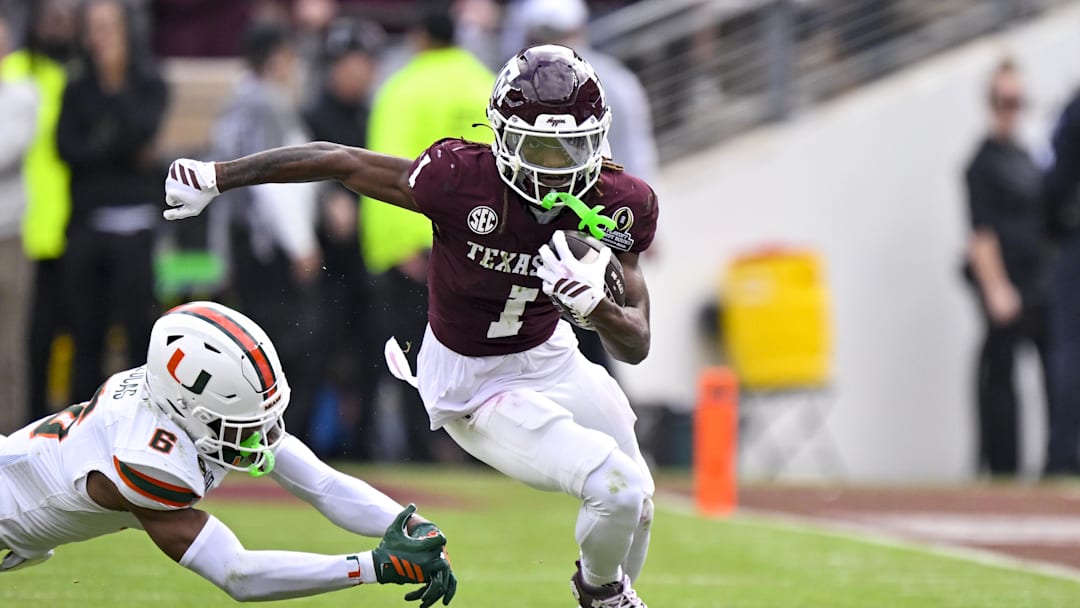 Dec 20, 2025; College Station, TX, USA; Texas A&M Aggies wide receiver Mario Craver (1) runs with the ball past Miami Hurricanes defensive back Xavier Lucas (6) during the game between the Aggies and the Hurricanes at Kyle Field. Mandatory Credit: Jerome Miron-Imagn Images