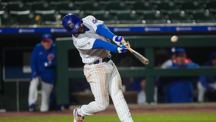 Iowa Cubs third baseman Jake Slaughter (28) hits the ball during the season opener at Principal Park