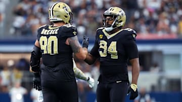 Sep 15, 2024; Arlington, Texas, USA; New Orleans Saints defensive end Cameron Jordan (94) celebrates with New Orleans Saints defensive tackle Bryan Bresee (90) during the second half against the Dallas Cowboys at AT&T Stadium. Mandatory Credit: Kevin Jairaj-Imagn Images