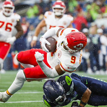 Aug 15, 2025; Seattle, Washington, USA; Seattle Seahawks quarterback Jalen Milroe (6) tackles Kansas City Chiefs wide receiver JuJu Smith-Schuster (9) short of a first down during the first quarter at Lumen Field. Mandatory Credit: Joe Nicholson-Imagn Images