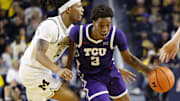 Nov 15, 2024; Ann Arbor, Michigan, USA;  TCU Horned Frogs guard Vasean Allette (3) dribbles against Michigan Wolverines guard Rubin Jones (15) in the second half at Crisler Center. Mandatory Credit: Rick Osentoski-Imagn Images