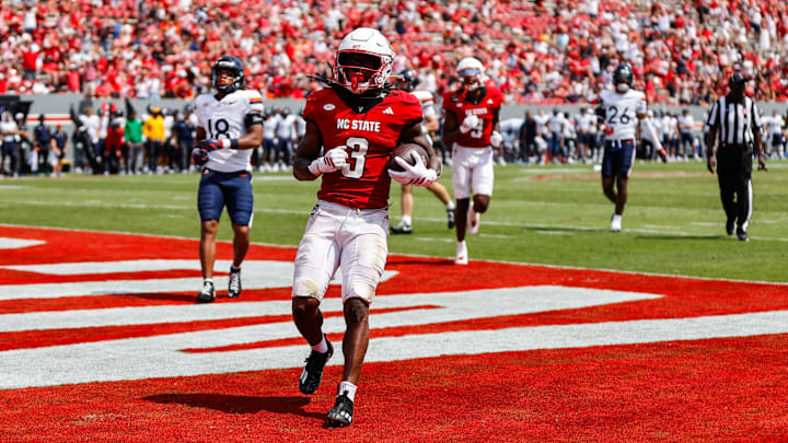 Sep 6, 2025; Raleigh, North Carolina, USA; North Carolina State Wolfpack running back Hollywood Smothers (3) runs with the football to score a touchdown during the second half of the game against Virginia Cavaliers at Carter-Finley Stadium. Mandatory Credit: Jaylynn Nash-Imagn Images