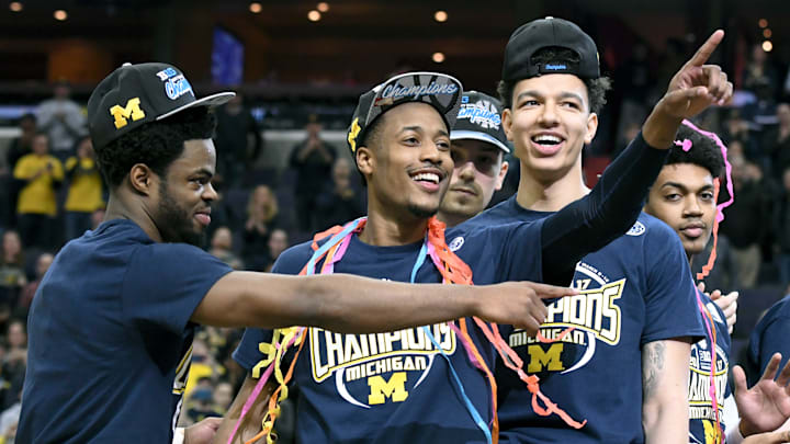 Standing (L-R), Michigan guard Derrick Walton Jr., guard Muhammad-Ali Abdur-Rahkman and forward D.J. Wilson celebrate winning the 2017 Big 10 tournament championship game. Standing (L-R), Michigan guard Derrick Walton Jr., guard Muhammad-Ali Abdur-Rahkman and forward D.J. Wilson celebrate winning the 2017 Big 10 tournament championship game.