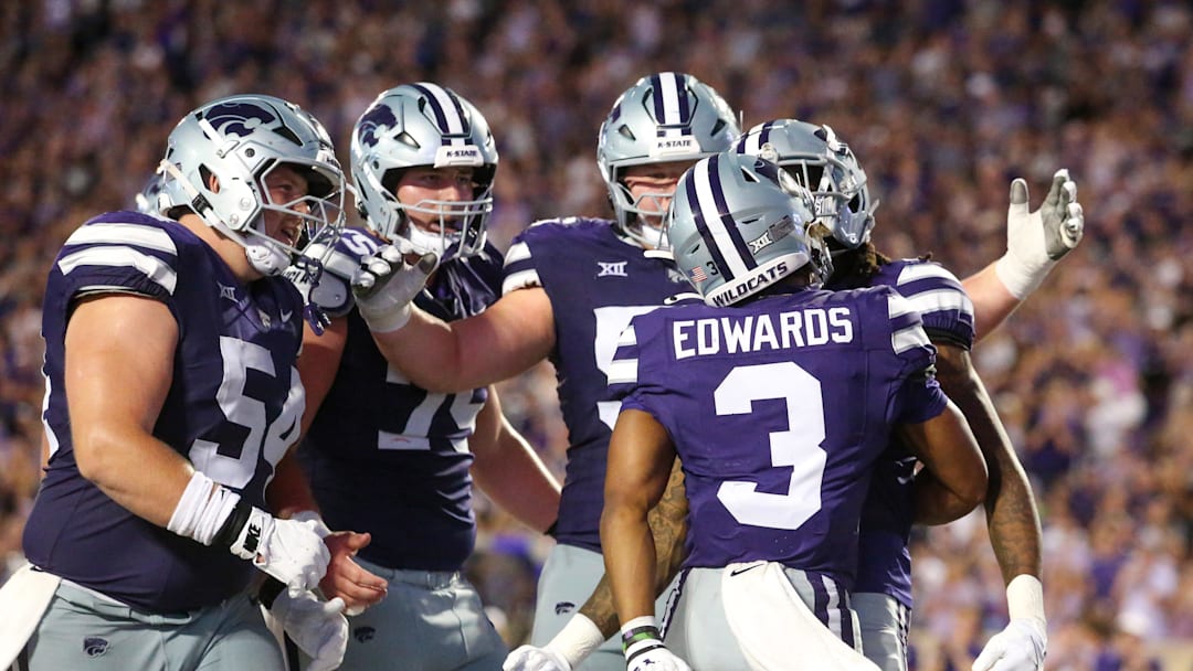 Aug 31, 2024; Manhattan, Kansas, USA; Kansas State Wildcats running back Dylan Edwards (3) is congratulated by teammates after scoring a touchdown in the third quarter against the Tennessee-Martin Skyhawks at Bill Snyder Family Football Stadium. Mandatory Credit: Scott Sewell-Imagn Images