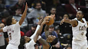 Dec 3, 2025; Cleveland, Ohio, USA; Portland Trail Blazers guard Caleb Love (2) shoots against Cleveland Cavaliers guard Craig Porter Jr. (9), guard Darius Garland (10) and center Evan Mobley (4) in the fourth quarter at Rocket Arena. Mandatory Credit: David Richard-Imagn Images