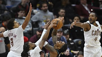 Dec 3, 2025; Cleveland, Ohio, USA; Portland Trail Blazers guard Caleb Love (2) shoots against Cleveland Cavaliers guard Craig Porter Jr. (9), guard Darius Garland (10) and center Evan Mobley (4) in the fourth quarter at Rocket Arena. Mandatory Credit: David Richard-Imagn Images