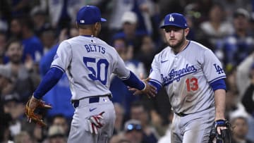 May 11, 2024; San Diego, California, USA; Los Angeles Dodgers third baseman Max Muncy (13) is congratulated by Los Angeles Dodgers shortstop Mookie Betts (50) after a defensive play against the San Diego Padres to end the eighth inning at Petco Park. Mandatory Credit: Orlando Ramirez-USA TODAY Sports