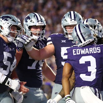 Aug 31, 2024; Manhattan, Kansas, USA; Kansas State Wildcats running back Dylan Edwards (3) is congratulated by teammates after scoring a touchdown in the third quarter against the Tennessee-Martin Skyhawks at Bill Snyder Family Football Stadium. Mandatory Credit: Scott Sewell-Imagn Images