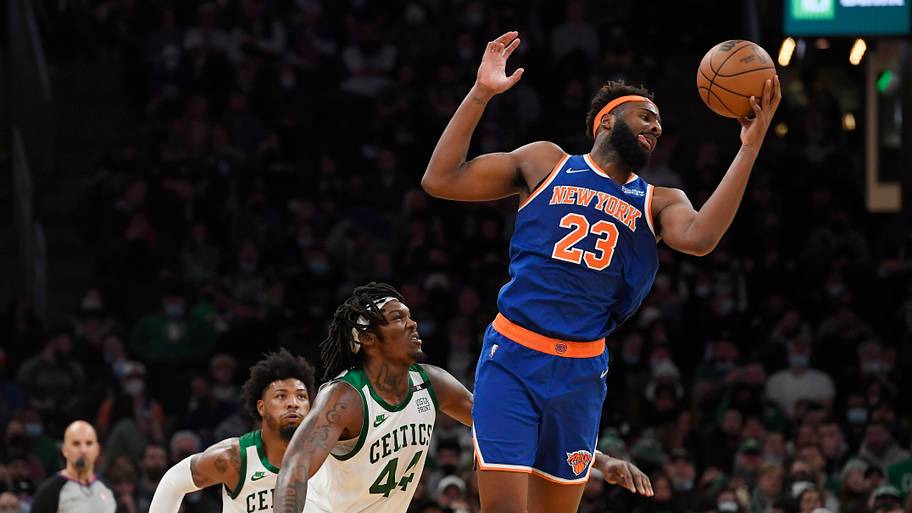 New York Knicks center Mitchell Robinson grabs a rebound over Boston Celtics center Robert Williams III.