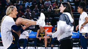 Indiana Fever guard Sophie Cunningham talks with Indiana Fever guard Caitlin Clark before the game against the Washington Mystics at Entertainment & Sports Arena. 