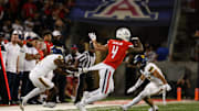 Sep 7, 2024; Tucson, Arizona, USA; Northern Arizona Lumberjacks center back DJ Vanhook (4) attempts to tackle Arizona Wildcats wide receiver Tetairoa McMillan (4) during the third quarter at Arizona Stadium.