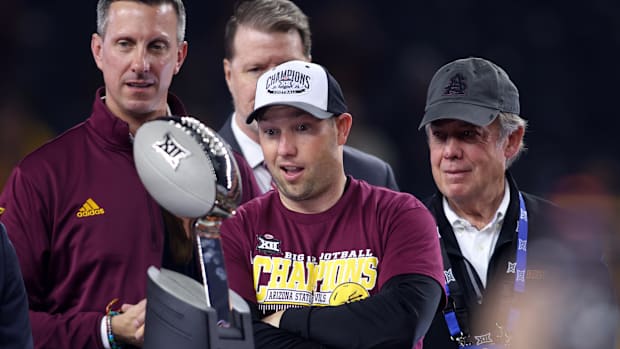 Arizona State Sun Devils head coach Kenny Dillingham looks at the trophy after winning the Big 12 Championship