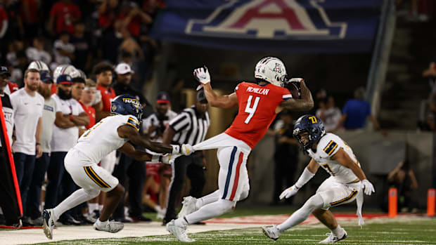 Tetairoa McMillan being tackled by North Arizona corner back DJ Vanhook.