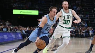 Mar 31, 2025; Memphis, Tennessee, USA; Memphis Grizzlies guard Luke Kennard (10) drives to the basket as Boston Celtics forward Sam Hauser (30) defends during the third quarter at FedExForum. Mandatory Credit: Petre Thomas-Imagn Images