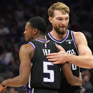 Dec 14, 2023; Sacramento, California, USA; Sacramento Kings guard De'Aaron Fox (5) is congratulated by forward Domantas Sabonis (10) after a basket against the Oklahoma City Thunder during the second quarter at Golden 1 Center. Mandatory Credit: Darren Yamashita-Imagn Images