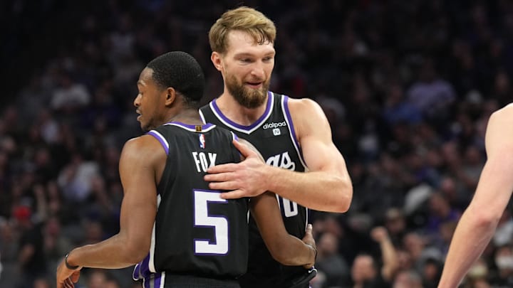 Dec 14, 2023; Sacramento, California, USA; Sacramento Kings guard De'Aaron Fox (5) is congratulated by forward Domantas Sabonis (10) after a basket against the Oklahoma City Thunder during the second quarter at Golden 1 Center. Mandatory Credit: Darren Yamashita-Imagn Images