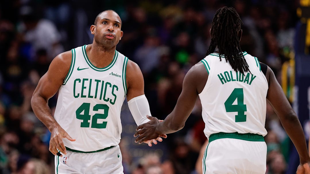 Jan 7, 2025; Denver, Colorado, USA; Boston Celtics center Al Horford (42) and guard Jrue Holiday (4) in the first quarter against the Denver Nuggets at Ball Arena. Mandatory Credit: Isaiah J. Downing-Imagn Images