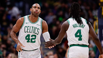 Jan 7, 2025; Denver, Colorado, USA; Boston Celtics center Al Horford (42) and guard Jrue Holiday (4) in the first quarter against the Denver Nuggets at Ball Arena. Mandatory Credit: Isaiah J. Downing-Imagn Images