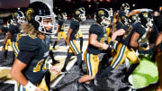 Oct 20, 2023; Carrollton, GA, USA; Carrollton Trojans quarterback Julian Lewis (10) enters the field against the Westlake Lions at Grisham Stadium. The 15-year-old Carrollton High student has already committed to playing for the University of Southern California Trojans and has been considered one of the top high school quarterback prospects. Mandatory Credit: John David Mercer-USA TODAY Sports